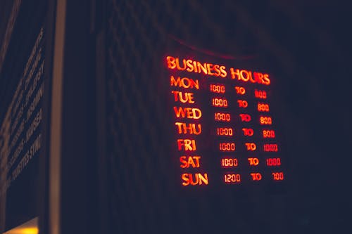 Bright board with business hours of cafe