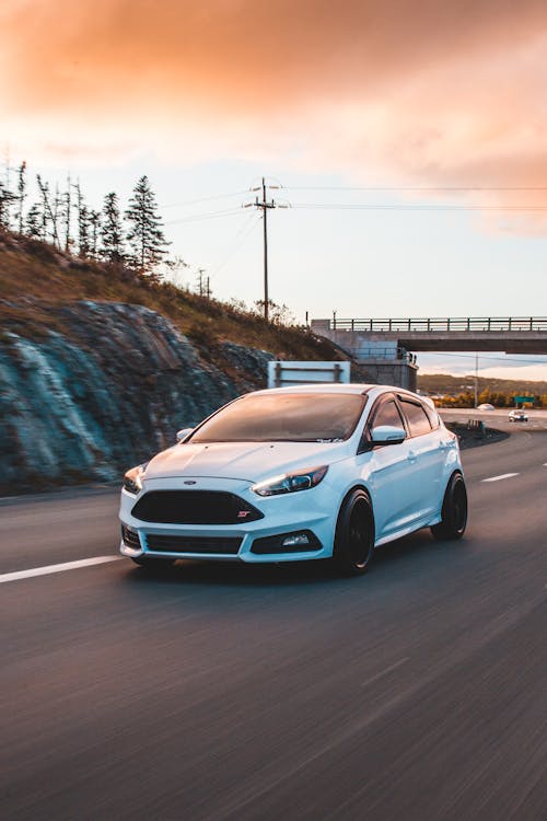 Free Modern sports car driving through countryside Stock Photo