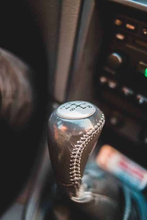 Free From above of manual transmission for gear shifting with dashboard with switches and buttons in modern auto Stock Photo