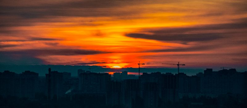 Stunning view of Kyiv's skyline under a vibrant and dramatic sunset. Perfect for travel and cityscape enthusiasts.
