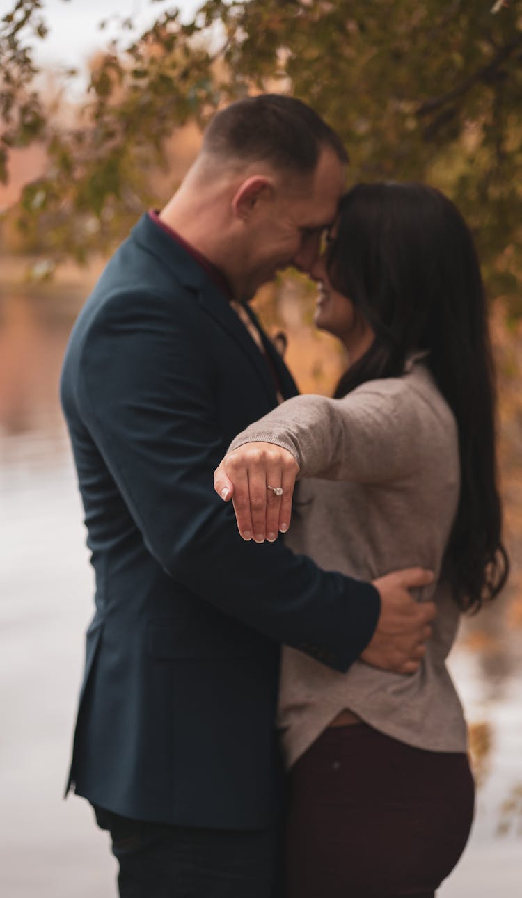 A Woman Showing Her Hand With An Engagement Ring