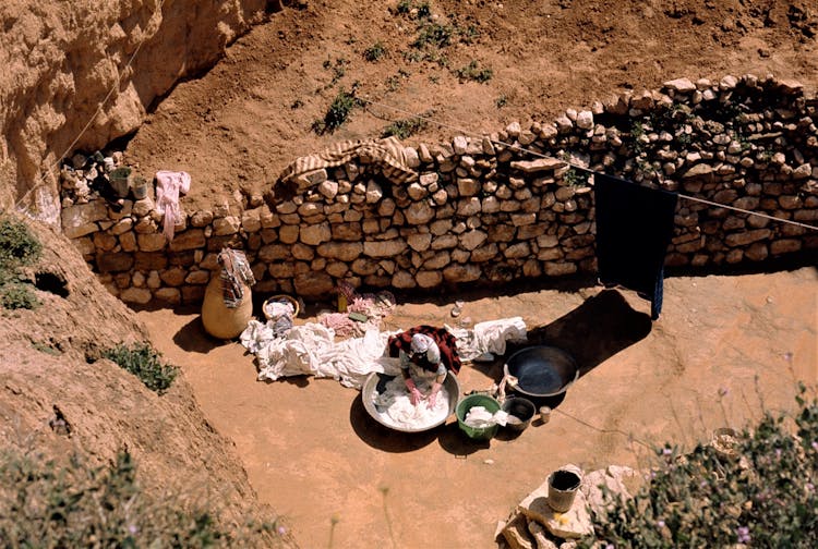 Drone Shot Of A Person Washing Clothes