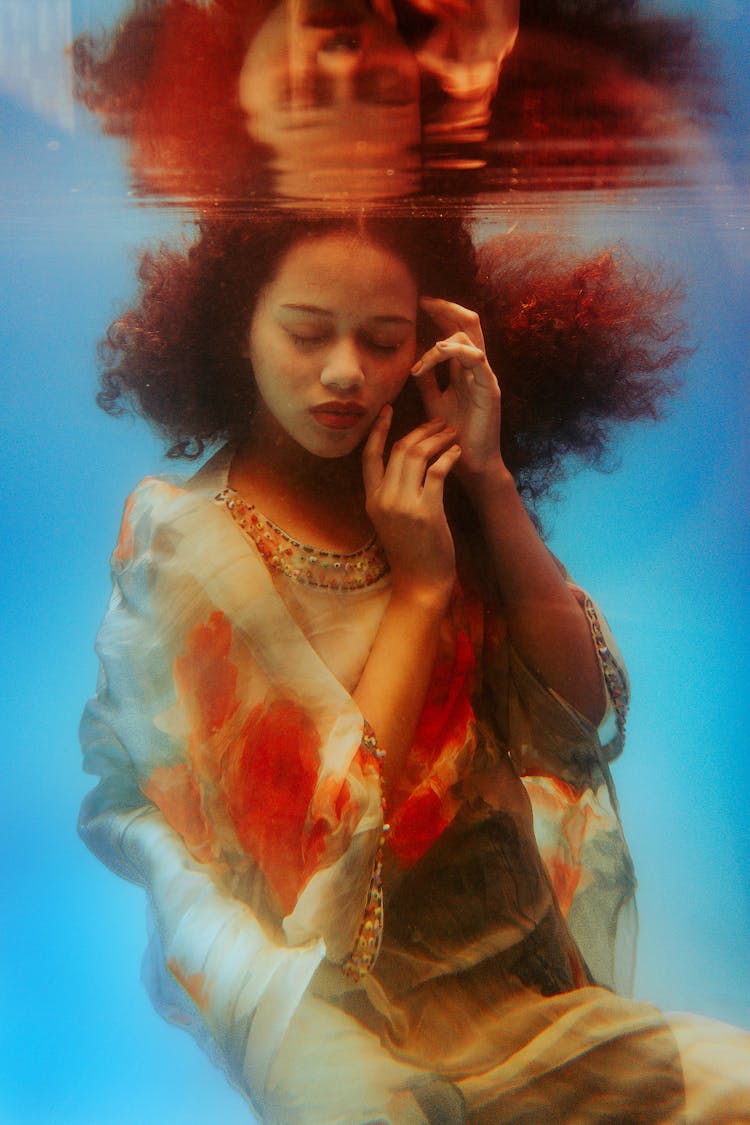 Serene Stylish Woman Touching Face Underwater