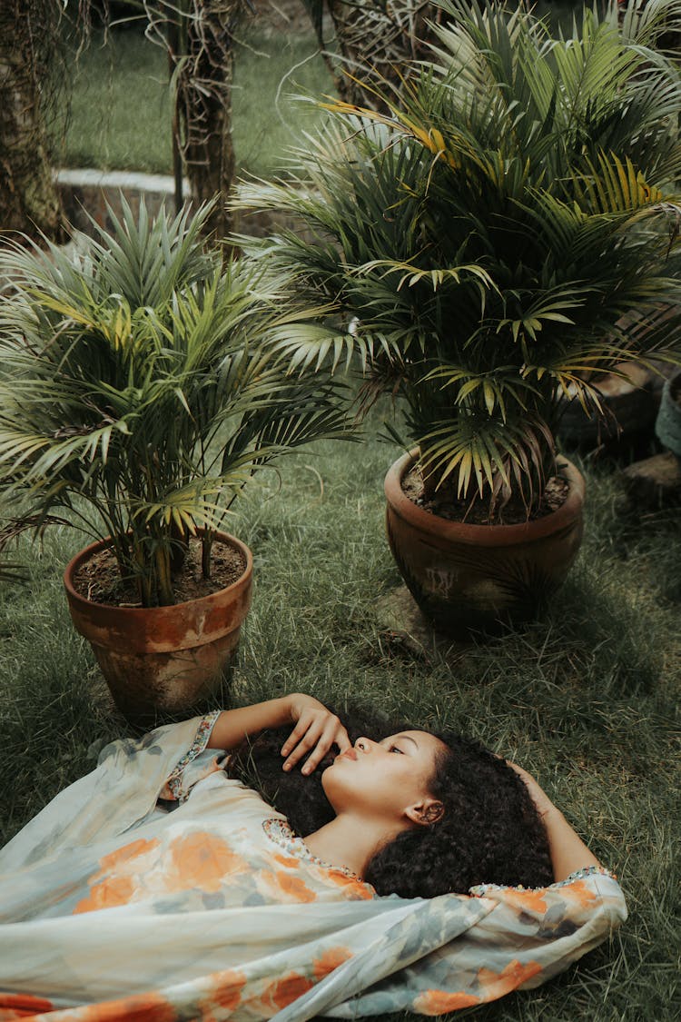 Beautiful Ethnic Woman Lying On Grassy Lawn In Park