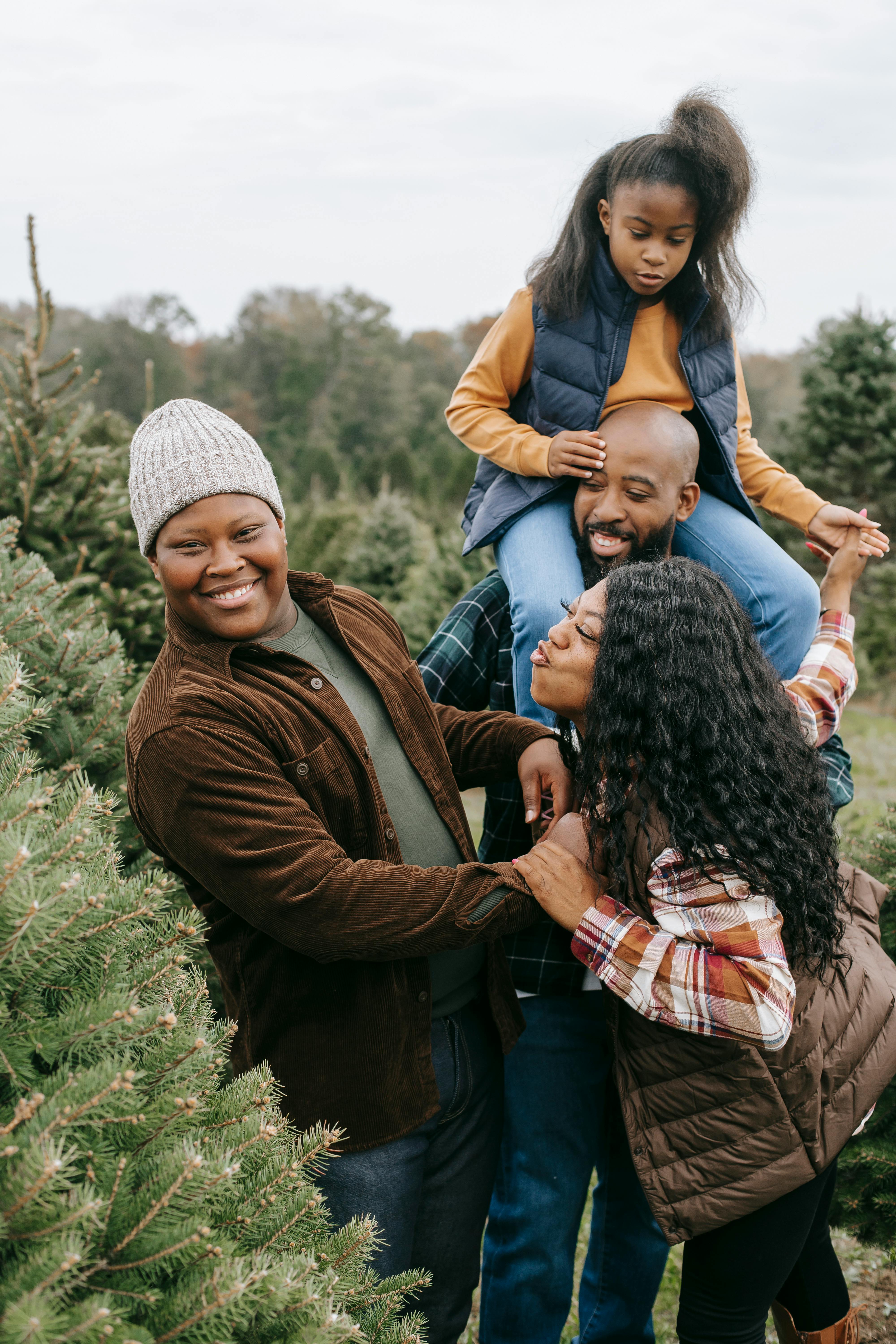 happy black family having fun in fir tree farm