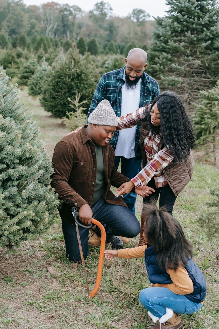 Black Positive Family Preparing For Sawing Christmas Tree