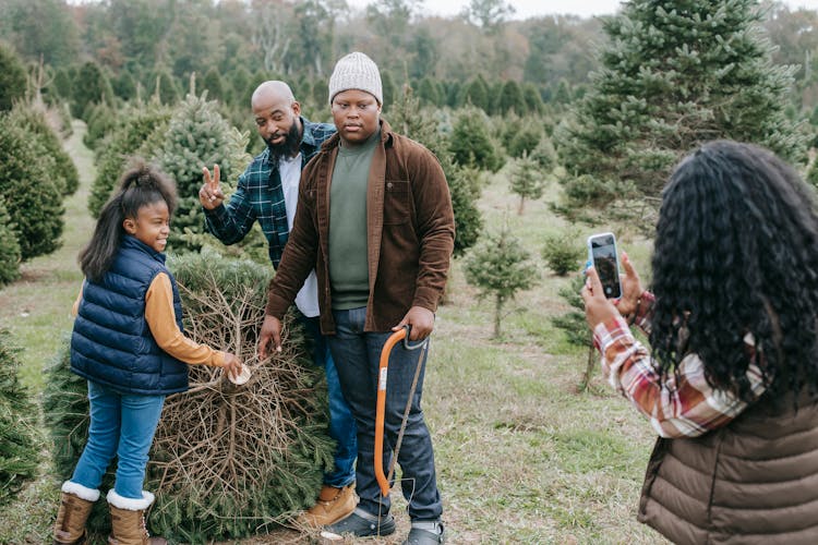 Woman Taking Photo Of Black Family