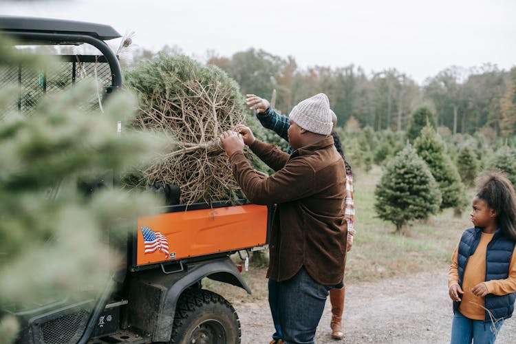 Anonymous Black Family Loading Tree In Trunk