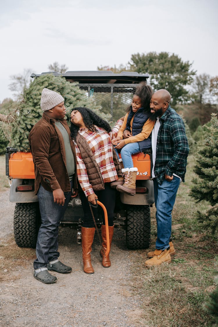 Black Family Near Quad Bike On Tree Farm