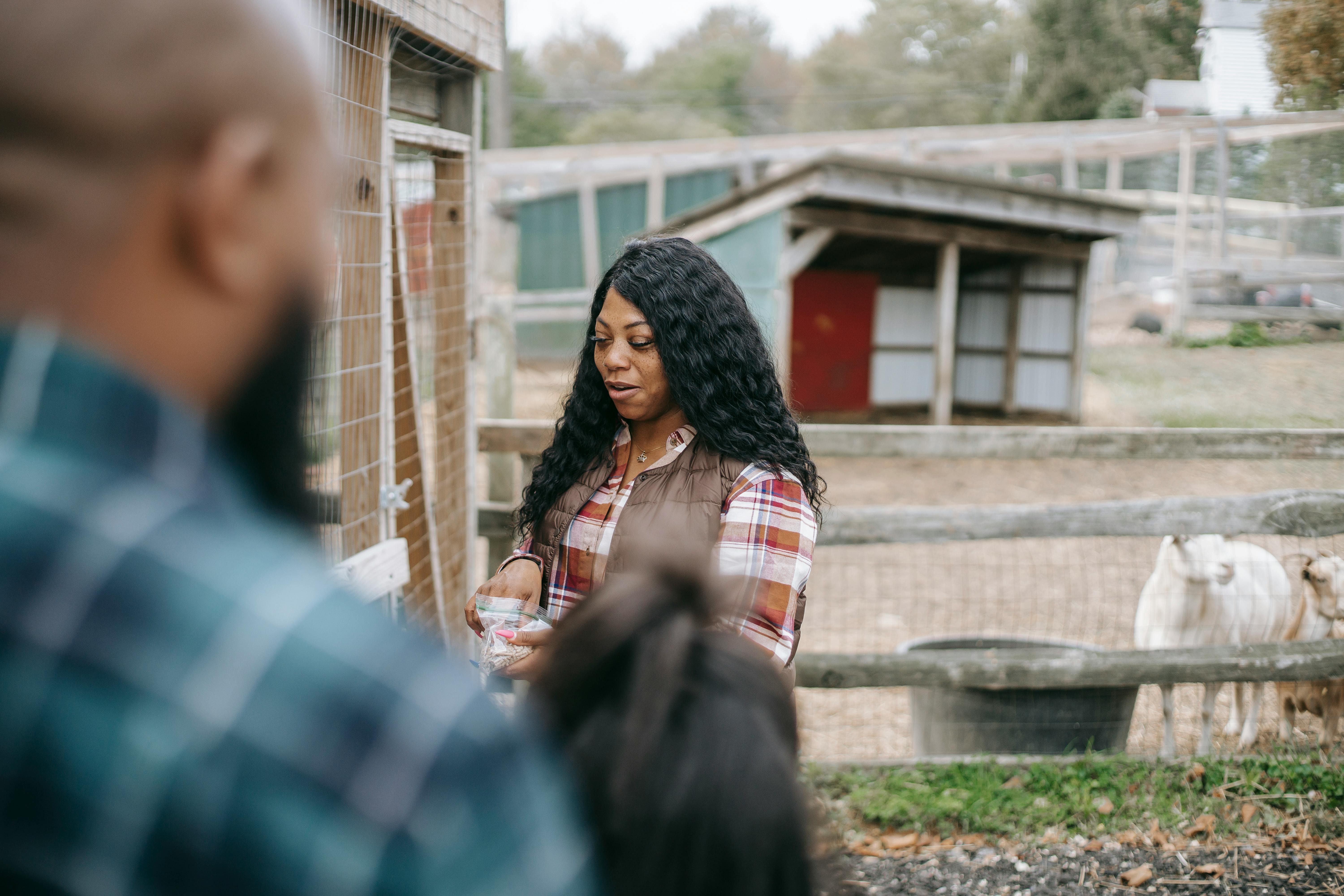 black woman near crop husband and daughter in countryside