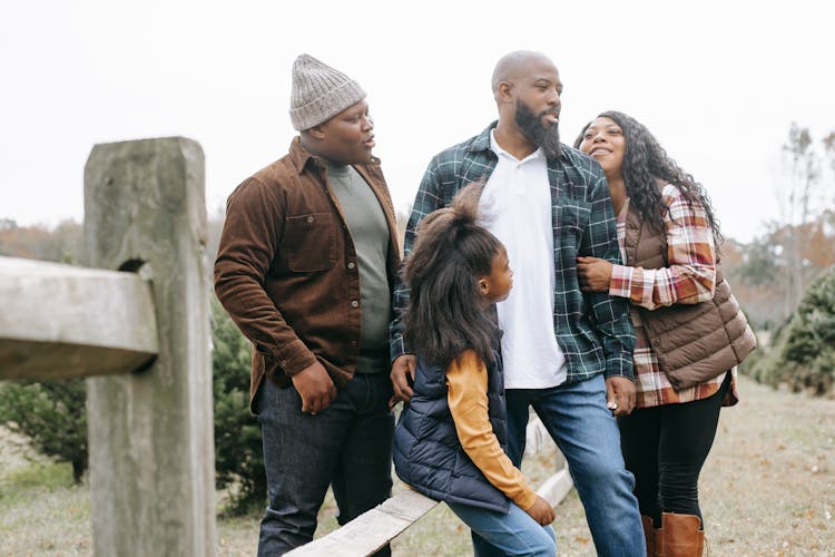 African American Family Near Fence On Farm