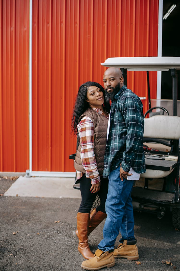 Black Couple Standing Close Near Vehicle And Fence