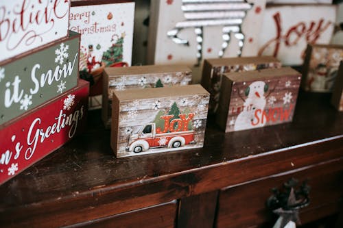 Collection of bright boxes with New Year ornament on wooden table during festive event