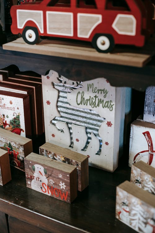 Collection of decorative Christmas boxes on wooden shelves
