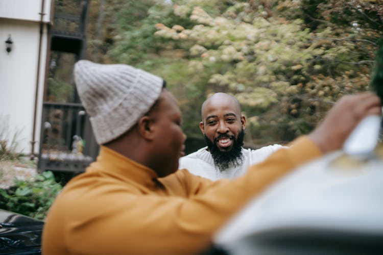 Smiling Hipster Man Speaking With Black Son Near Trees