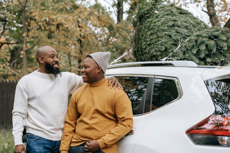 Cheerful Bearded Black Father Embracing Teen Near Car In Countryside