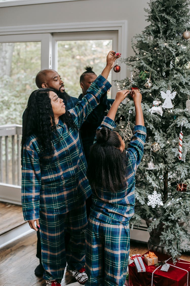 Black Family Decorating Christmas Tree With Toys