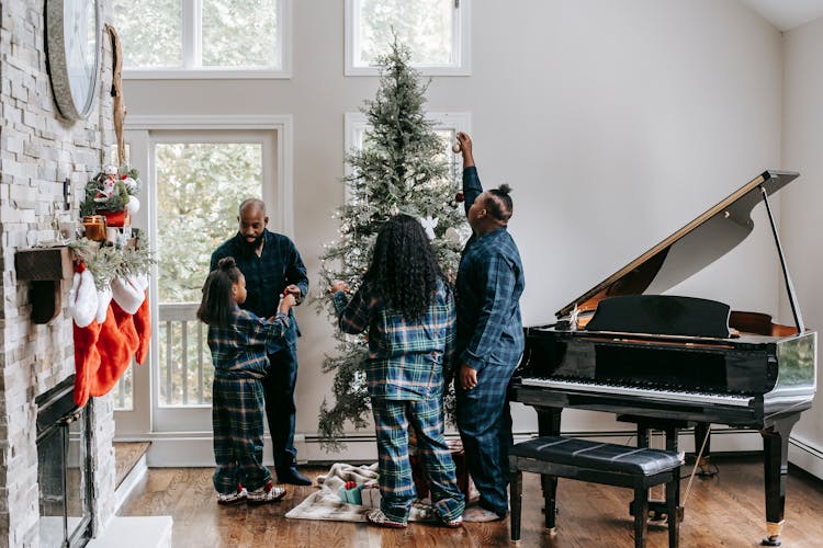 Black Family Decorating Christmas Tree Together