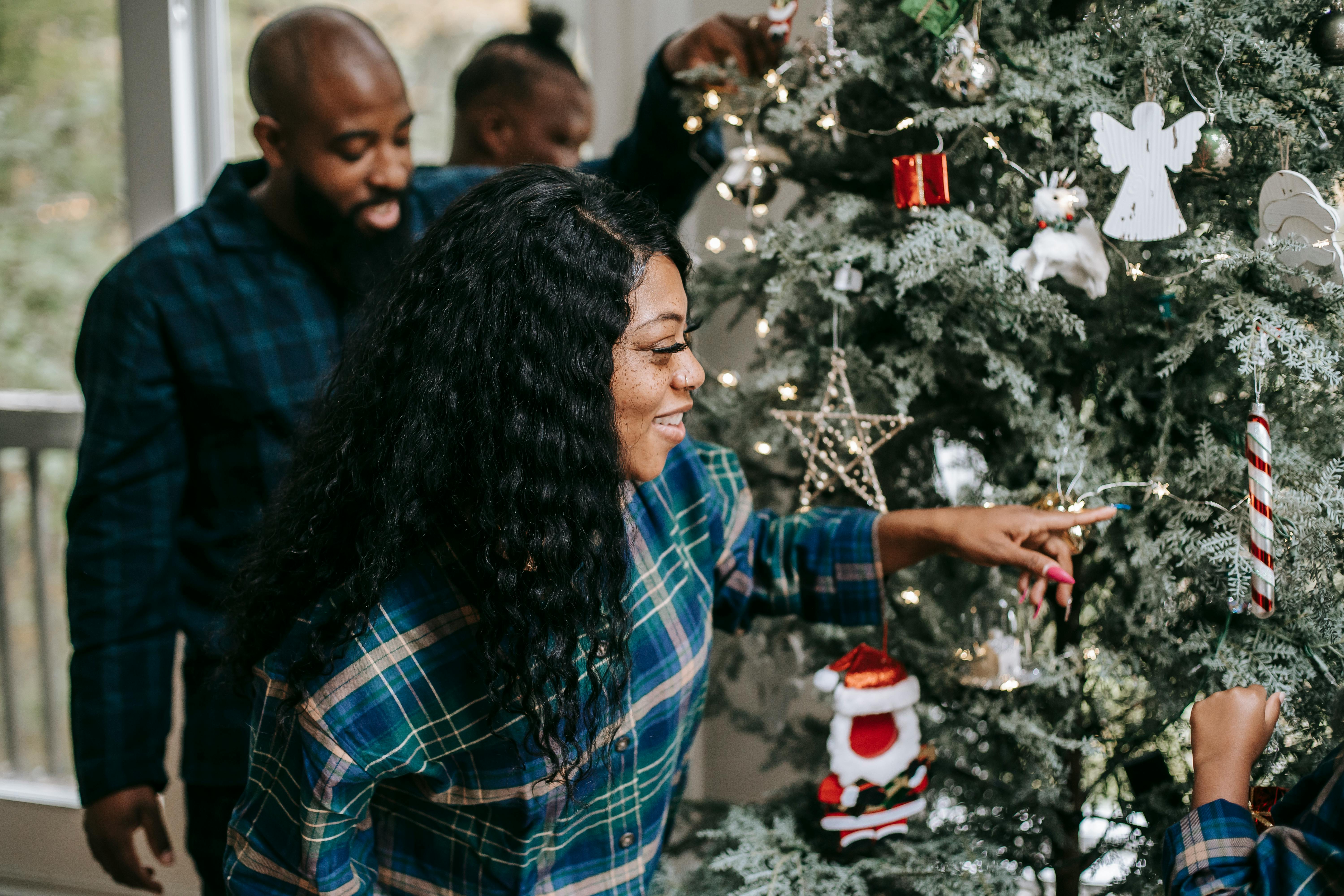 cheerful black family enjoying xmas decorations