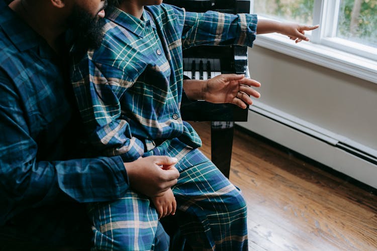 Black Father With Kid Pointing At Window