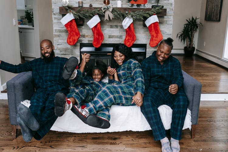 Glad Black Family Having Fun On Couch