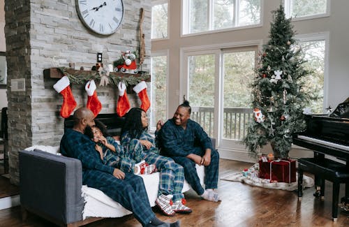 Happy black family enjoying Christmas holidays at home