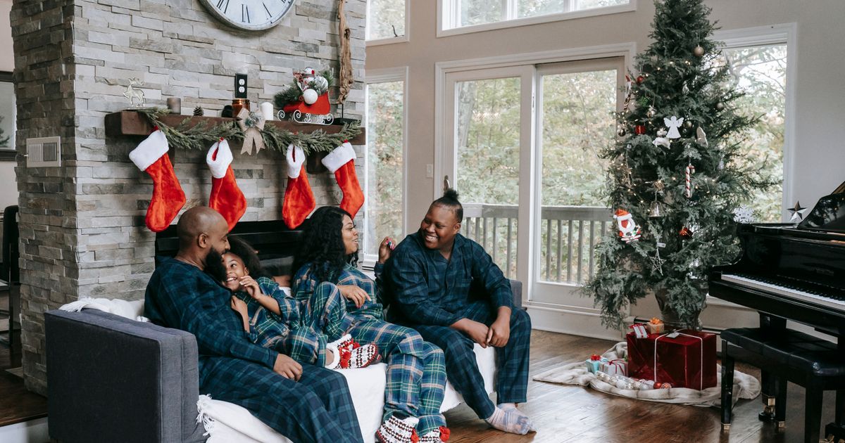 Happy family enjoying Christmas morning in a cozy decorated living room