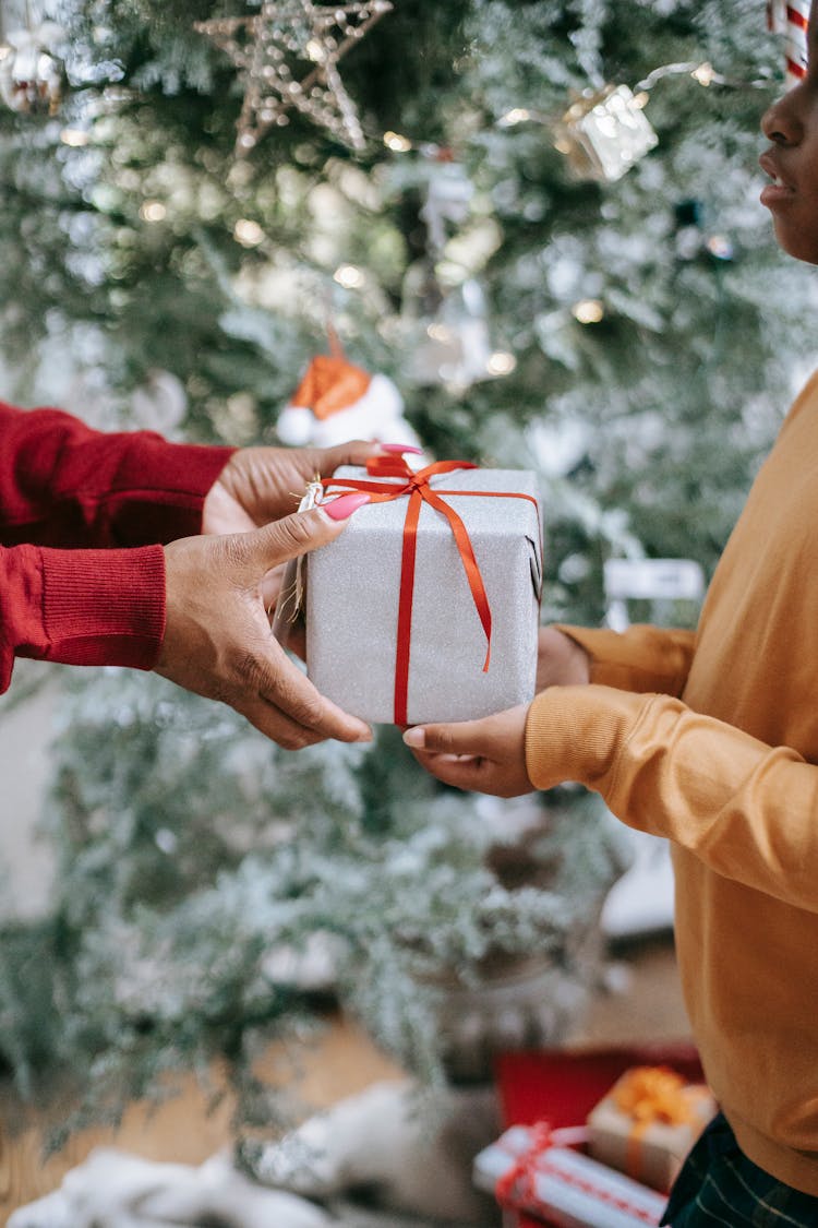 Black Woman Giving Gift To Kid