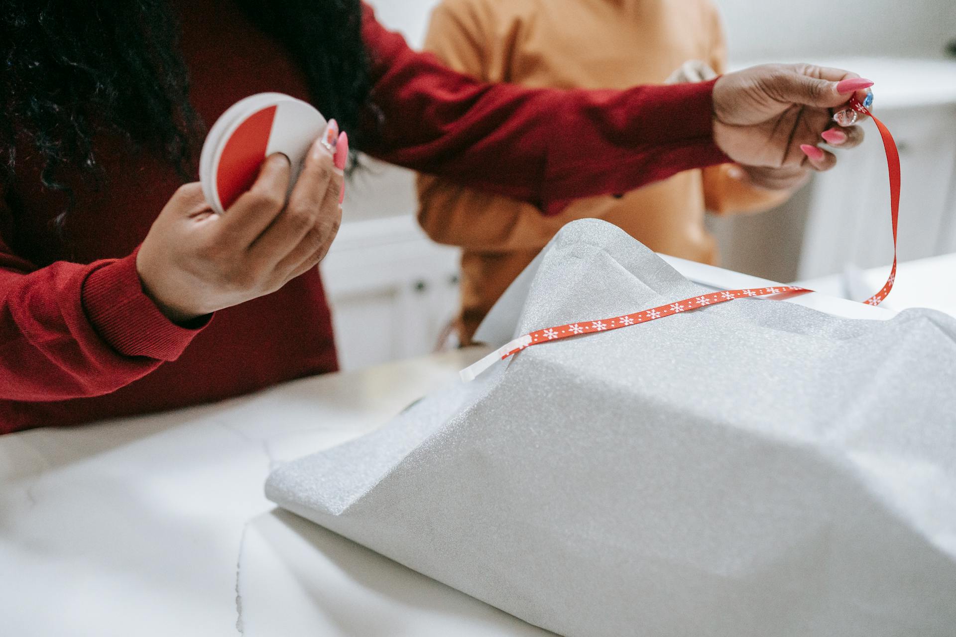 Black woman and kid wrapping gifts for New Year