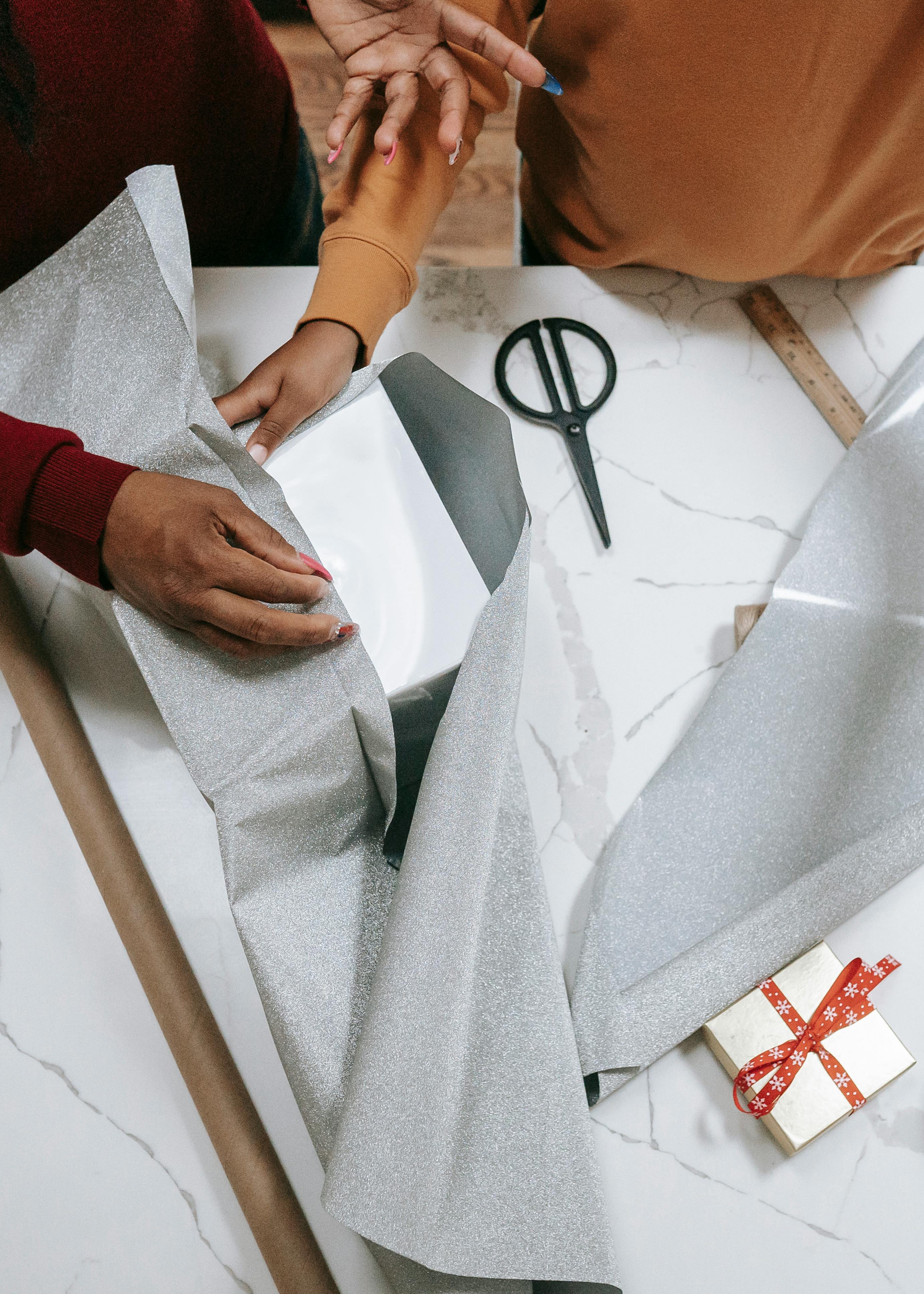 crop black woman with child packaging christmas presents