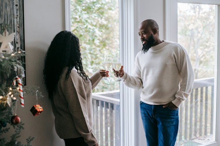 Black Hipster Man Sharing Champagne With Girlfriend