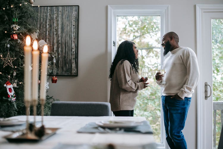 Smiling Black Couple With Glass Of Champagne Celebrating Christmas Holiday