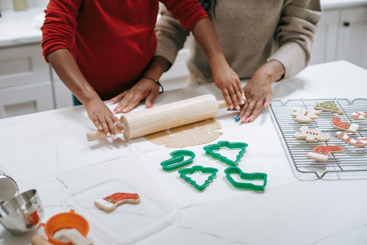 Crop Black Kid Helping Mother Rolling Out Dough For Pastries