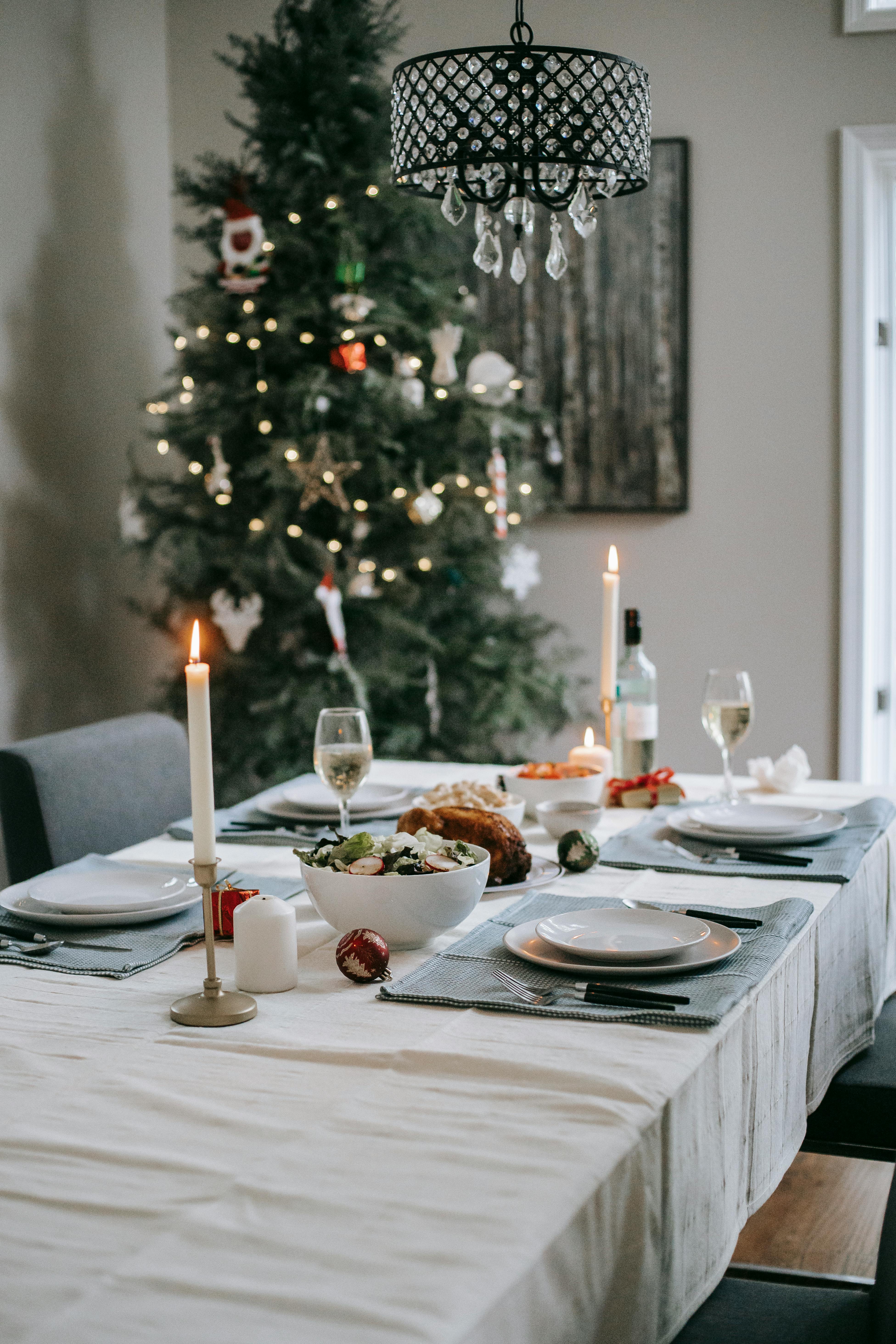 served table with tasty food near christmas tree at home