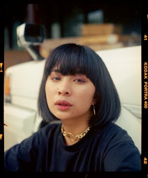 A captivating portrait of a young woman with bangs and a nose piercing, showcasing her unique style.