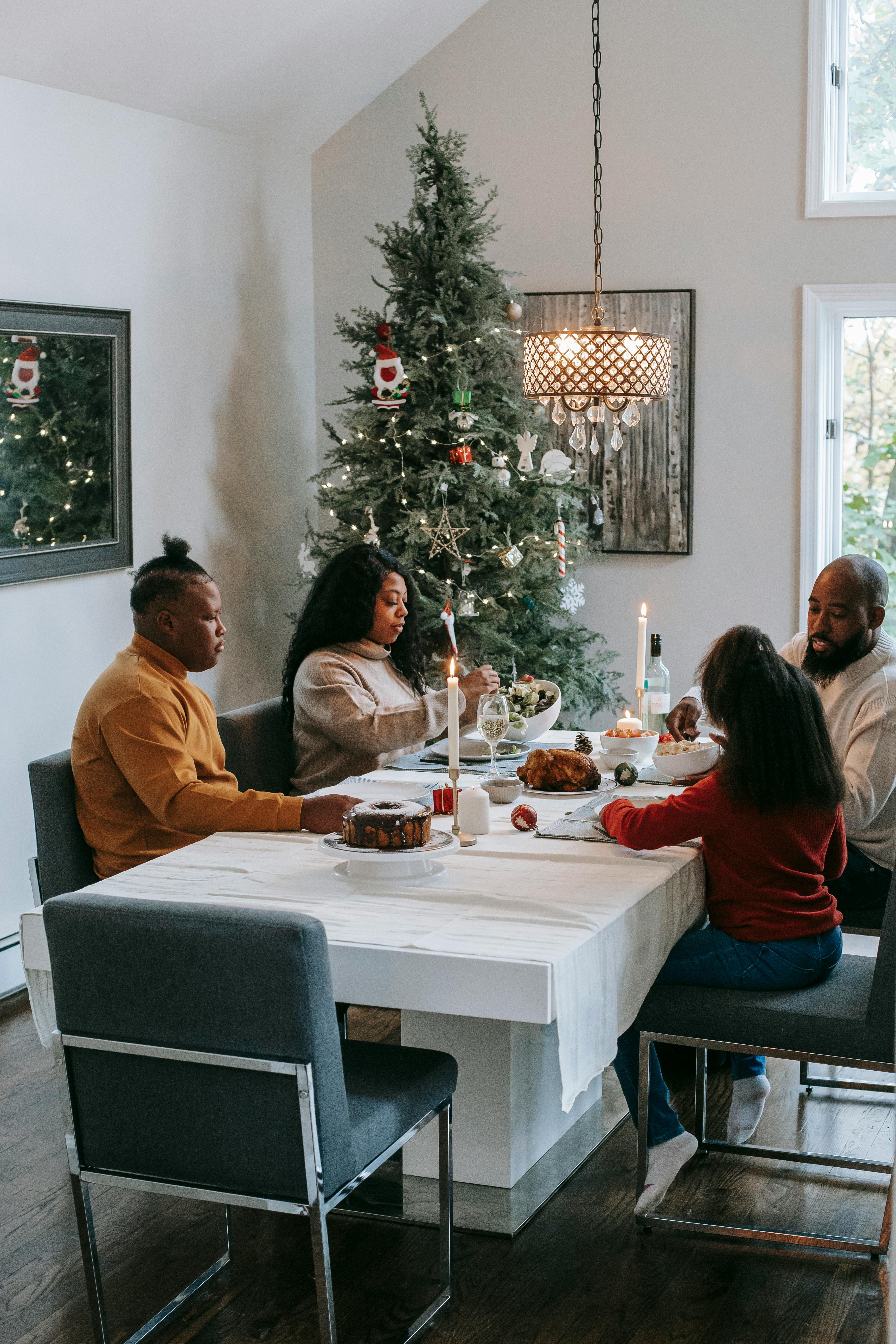 black family celebrating christmas at served table at home