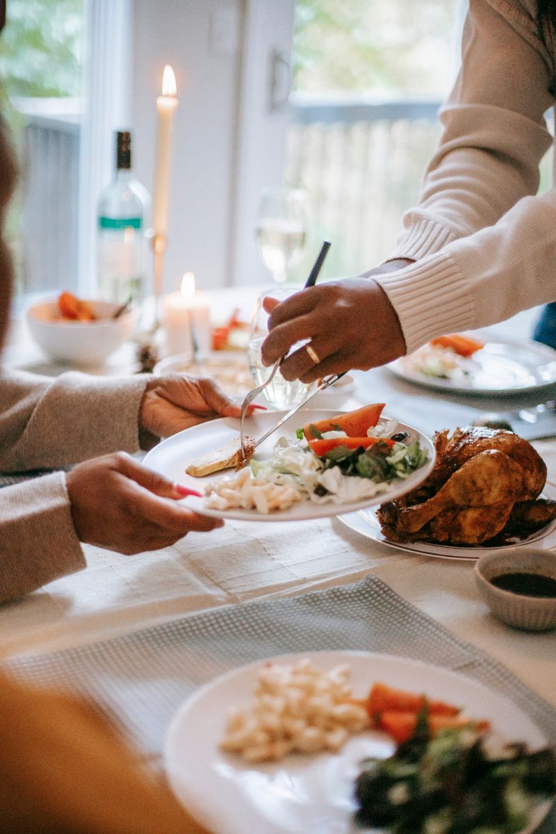 A festive Thanksgiving dinner being served with roast turkey and fresh salad on a table.