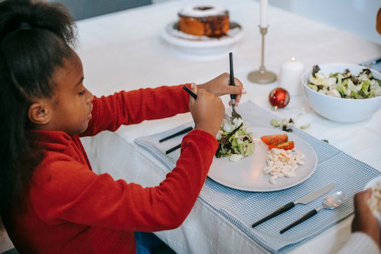 Black Girl Having Dinner At Table