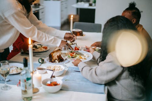 Man in White Long Sleeve Shirt Sitting Beside Woman in White Long Sleeve Shirt