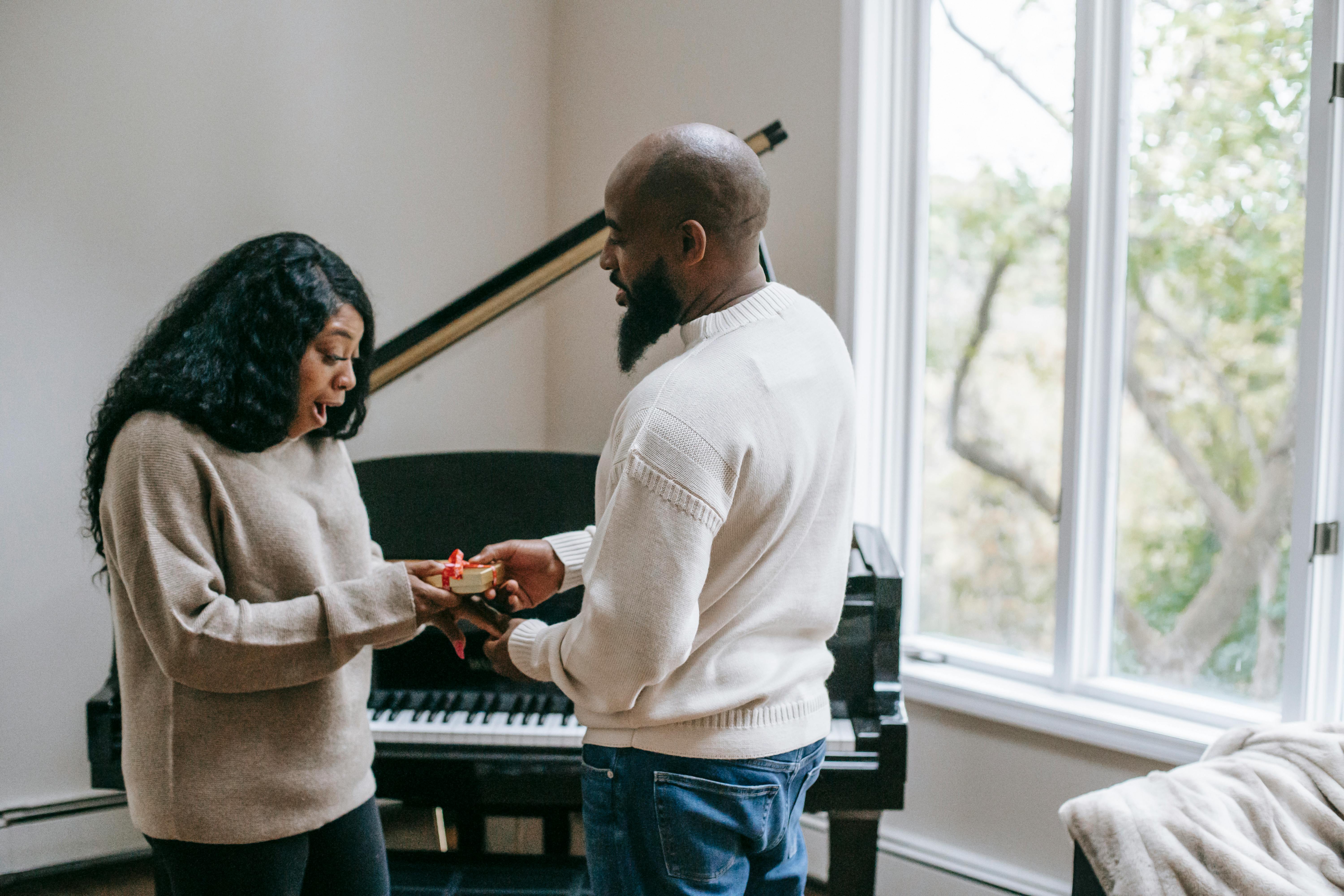 black man giving present to wife