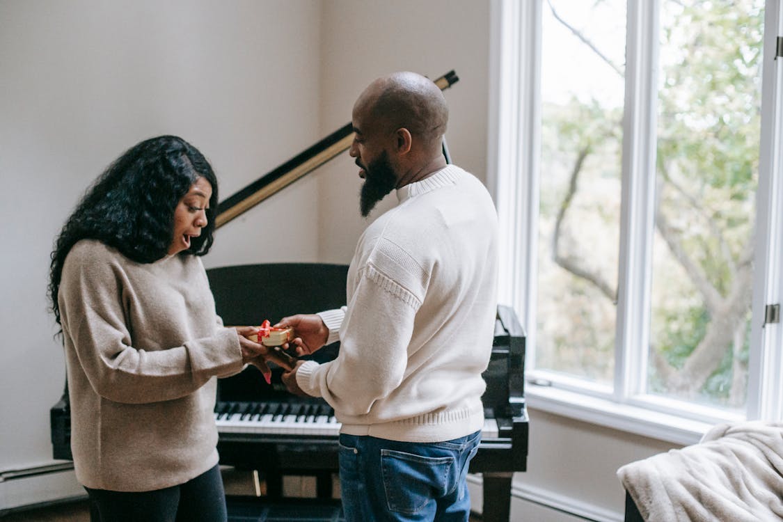 Black man giving present to wife