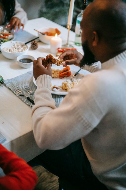 Free Crop anonymous African American couple celebrating festive event with delicious meal on holiday Stock Photo