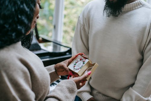 Free Black woman receiving present from man Stock Photo