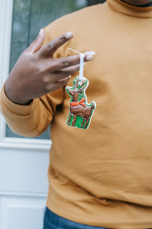 Black man showing bright figure of Christmas reindeer