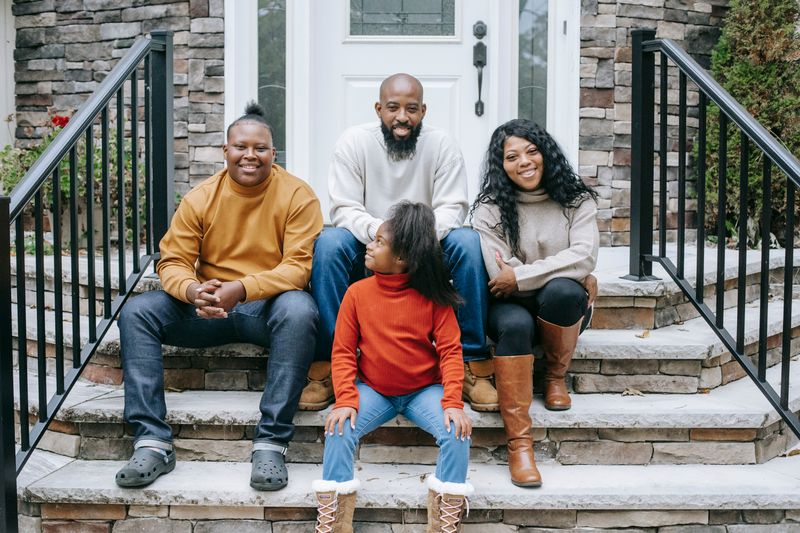 Family on the steps of their new PartNerd-built home