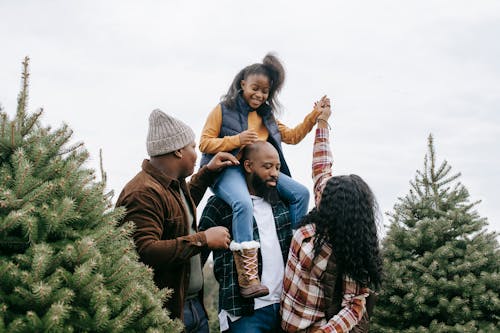 Family Together Between Needle Trees