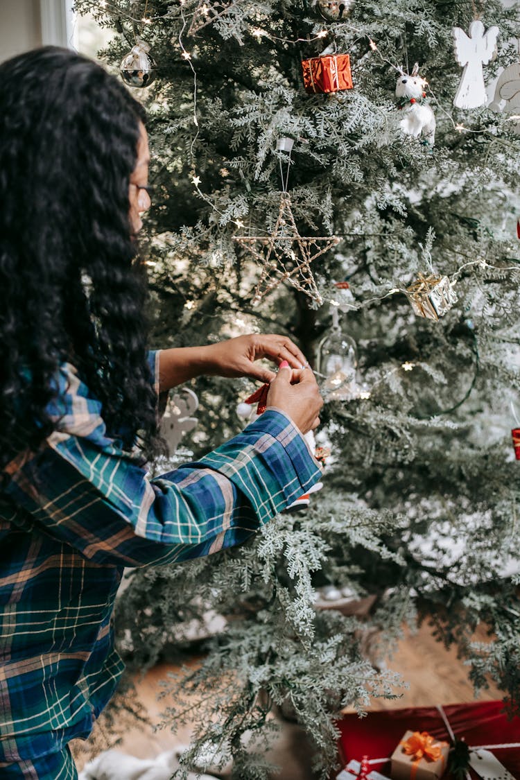 Black Woman Decorating Christmas Tree With Toys