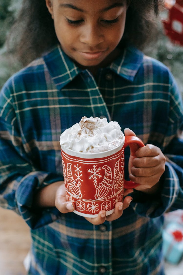 Photograph Of A Child Holding A Mug With White Whipped Cream