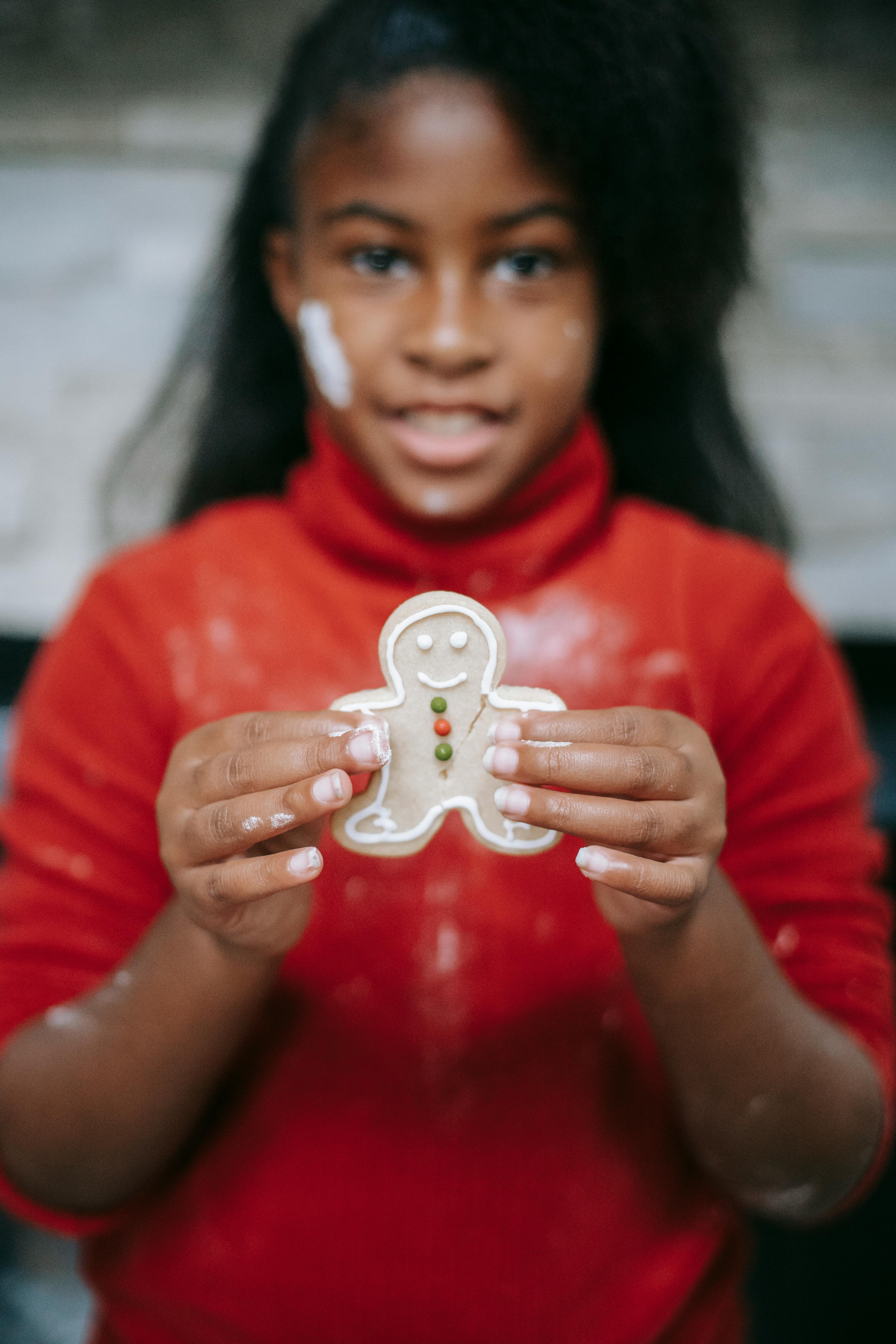 cute black girl showing homemade gingerbread man