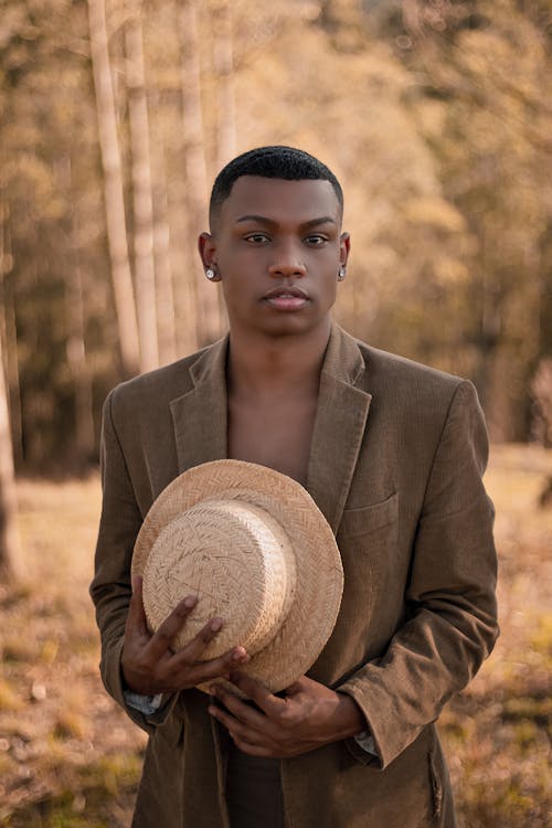 Black man with hat looking at camera